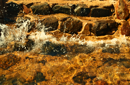 Beautiful summer landscape - the sea wave is breaking on the steps of stone leading to the beach, in Egyptの写真素材