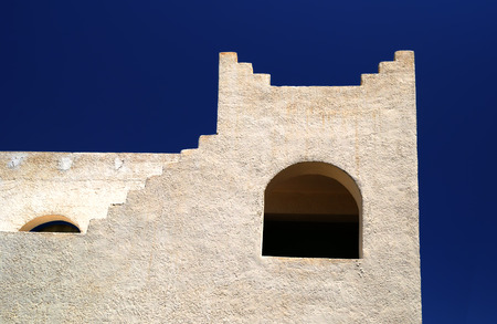 Architectural rough structure of white color in Oriental style on the background of dark blue skyの写真素材