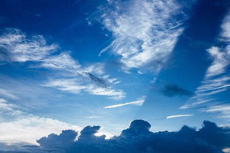 Bright and beautiful photos of heavenly white clouds and saturated blue sky with sunlight. Light, delicate and airy cloudy background with white and blue colors. Place to print. Nice backgroundの写真素材