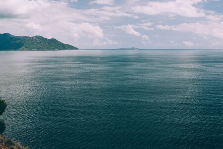 Tropical seascape with turquoise sea, white clouds in the sky, beautiful view of mountains, Asia, Vietnamの写真素材