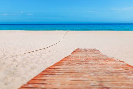 Empty sand beach with blue sea and blue sky background. Summer Vacation Travel and Holiday concept.の写真素材