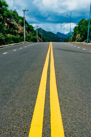 Mountain road. Summer time. Background, travel, landscape. Highway in the mountains. Good asphalt road with beautiful views. Transportの写真素材