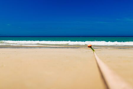 Empty sand beach with blue sea and blue sky background. Summer Vacation Travel and Holiday concept.の写真素材