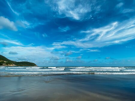 Seascape, sea view. Waves at sea, sea tide, sandy shore. Sea foam. Beautiful clouds in the blue sky. Traveling in Asia.の写真素材