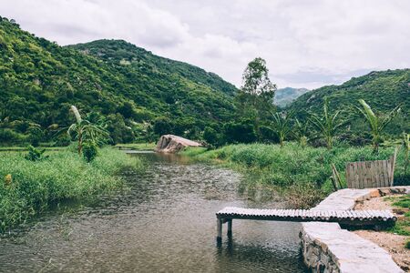 Rural landscape, view of rice fields, beautiful view of mountains, rivers and a farm village. Blue sky with white clouds. Wonderful Asian landscapeの写真素材