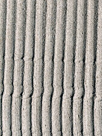 Sand, texture, fine grains of sand, brown, wet sand, background, place for textの写真素材