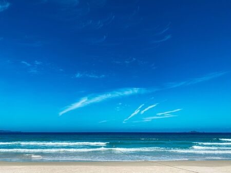 Blue sky with white clouds background. Clear sunny day, with scattered, beautiful clouds in a clear blue skyの写真素材