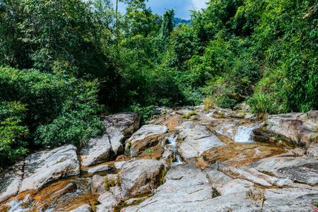 A small mountain river flows among large stones in mountainous areas through the forest. Natural landscape, with a clean river a beautiful landscape, clean air. Ecologically clean area.の写真素材