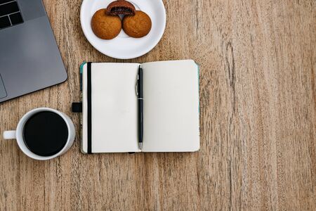 Flat lay of the workplace. Freelance work laptop smartphone and note pad. Morning coffee with...