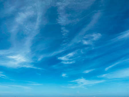 Blue sky with white clouds background. Clear sunny day, with scattered, beautiful clouds in a clear blue skyの写真素材