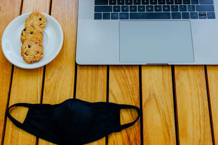 Workspace concept with gray modern laptop to work on wood brown office desk. Time for a coffee...