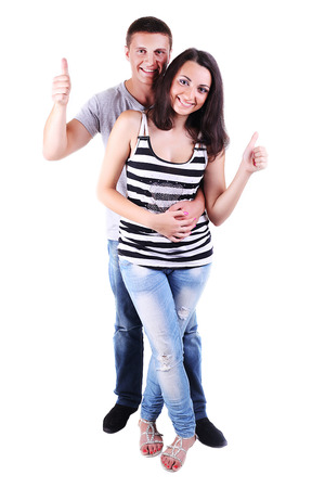 Portrait of a beautiful young happy smiling couple, thumb up - isolatedの写真素材