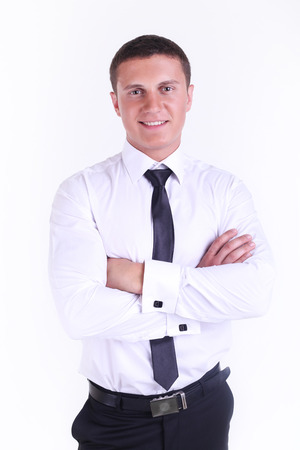 standing with his hands folded isolated on white backgroundの写真素材