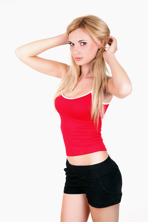 Girl in fitness clothes preparing for her exercises. Isolated on white background.の写真素材