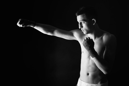 strong fighter boxing over black backgroundの写真素材