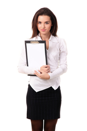 Isolated Studio Picture Of A Female Salesman Or Business Woman Holding A Blank Empty Clip Board Or Notice With Pen In A Business Contract Signature Conceptの写真素材