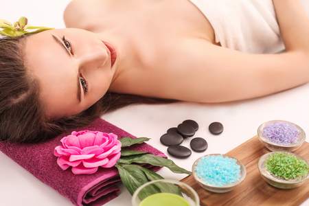 Beautiful young woman relaxing in the spa salon.の写真素材