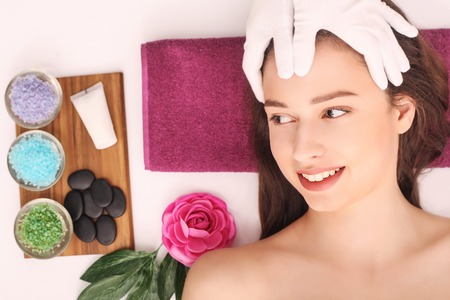 Beautiful woman relaxing and getting head massage.
