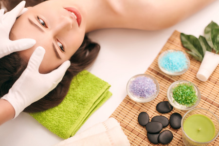 Woman under professional facial massage in beauty spa.の写真素材