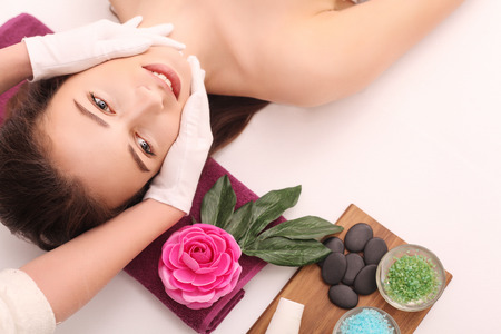 Woman under professional facial massage in beauty spa.の写真素材