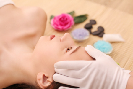 Beautiful young woman relaxing in the spa salon.の写真素材