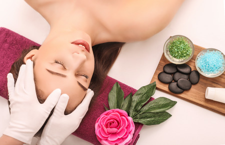 Woman under professional facial massage in beauty spa.の写真素材