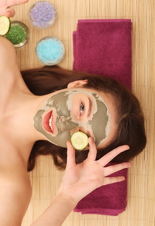 Spa. Care Facial. Woman taking care of her face in spa treatments.の写真素材