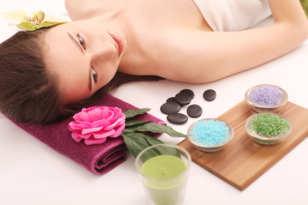 Spa. Care Facial. Beautiful young woman relaxing in the spa salon.の写真素材