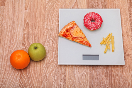 Diet. The concept of junk food on weight. Healthy Lifestyle. Wooden backgroundの写真素材