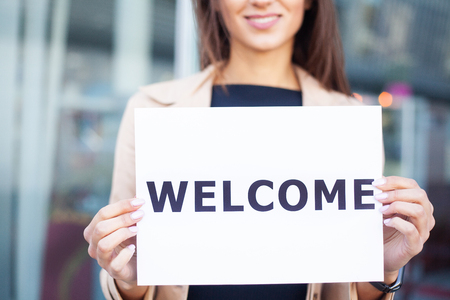 Women business with the poster with welcome messageの写真素材