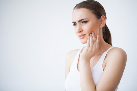 Tooth Pain. Dental care and toothache. Woman Feeling Tooth Pain. Closeup Of Beautiful Sad Girl Suffering From Strong Tooth Pain. Attractive Female Feeling Painful Toothache. Dental Health And Careの写真素材