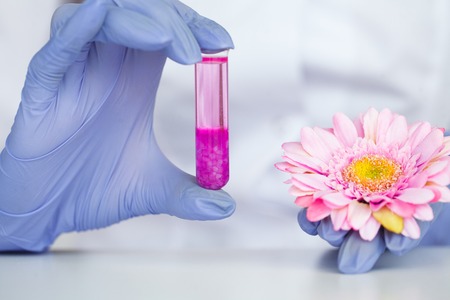 Biological test. Woman holding flask in lab. The scientist,dermatologist testing the organic natural product in the laboratoryの写真素材
