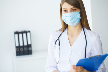 Clinic. Smiling young doctor in hospital corridorの写真素材