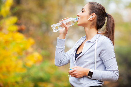 Sport outdoor. Woman Drinking Water After Runningの写真素材