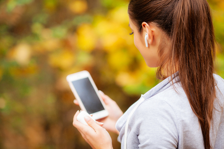 Woman Listening Music, Doing Workout Exercises On Streetの写真素材