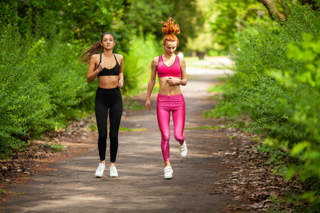 Runners training outdoors working out in the parkの写真素材