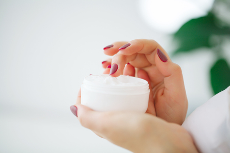 Beauty Skin Care. Beautiful Woman Applying Cosmetic Face Creamの写真素材