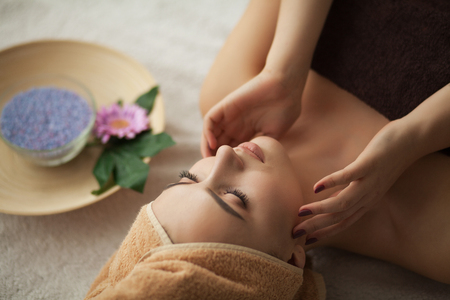 Face Massage. Close-up of a Young Woman Getting Spa Treatmentの写真素材