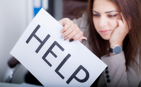 Close up girl hand putting signature on document. She situating at desk. Business concept. Low angle