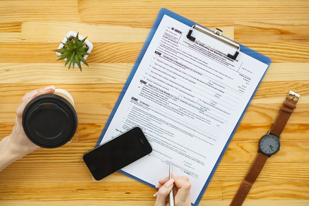 Woman hand writing or signing in a document