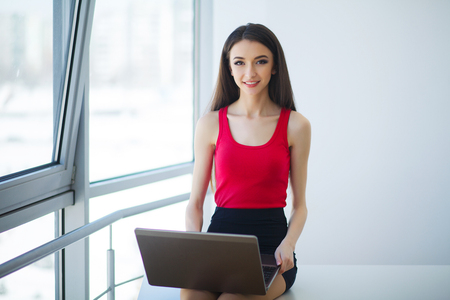 Young woman working on laptop in the officeの写真素材