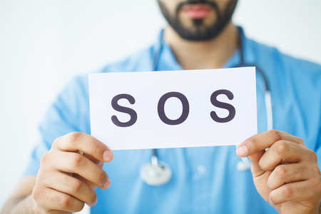 Health Care. Doctor Holding a Card With Symbol SOS, Medical Conceptの写真素材