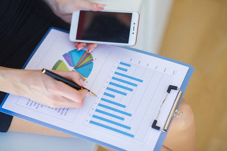 Close up female hands over business documentの写真素材