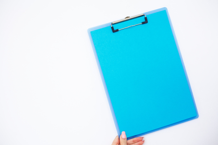 Blank Folder with Blue Paper. Hand that Holding Folder and Pen on White Background. Copyspace. Place for Textの写真素材
