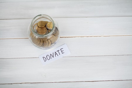 Donation Concept. Glass with Dollars on White Background. Donationsの写真素材