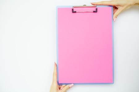 Blank Folder with Pink Paper. Hand that Holding Folder and Handle on White Background. Copyspace. Place for Textの写真素材