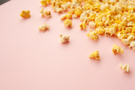 Food. Frozen Popcorn Corn Delicious Yellow Popcorn on Pink Background. Cinema. Copyspace. Place for Text.の写真素材
