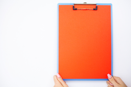 Blank Folder with range Paper. Hand that Holding Folder and Handle on White Background. Copyspace. Place for Textの写真素材