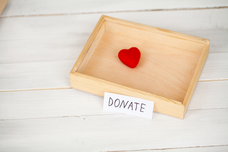 Donations and Charity. Donation Concept. Box of Donations and Heart on the White Backgroundの写真素材
