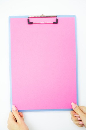 Blank Folder with Pink Paper. Hand that Holding Folder and Handle on White Background. Copyspace. Place for Textの写真素材